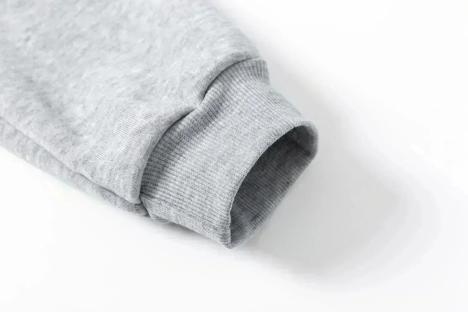 A man wearing the loose-fit Demon Slayer Anime Men Sweatpants with a Japanese cartoon print, showcasing a casual hip hop and Y2K streetwear style.