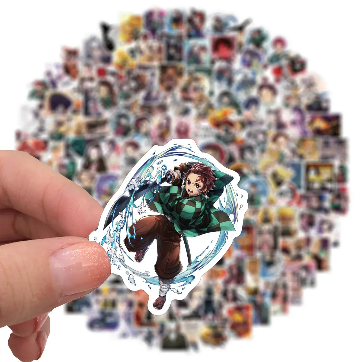A mixed pack of waterproof Demon Slayer Stickers featuring cute Tanjiro and Nezuko anime art, applied to a laptop and phone case.