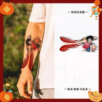One Piece Temporary Tattoo Stickers illustration showing Luffy with fire fist design on a forearm.