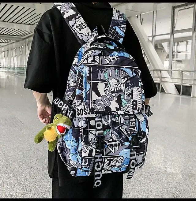 One Piece Luffy Backpack with graffiti print and plush toy, perfect for school and daily use.