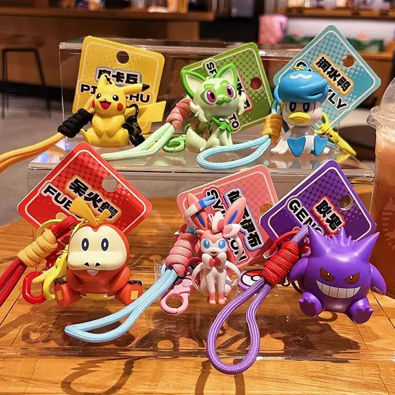 A Genuine Pokemon Keychain featuring a 3D Pikachu and Gengar anime action figure with a fragrance pendant design for backpacks.