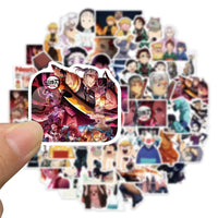A mixed pack of waterproof Demon Slayer Stickers featuring cute Tanjiro and Nezuko anime art, applied to a laptop and phone case.