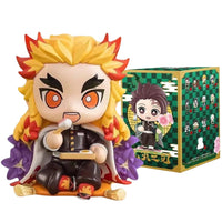 A colorful Demon Slayer Blind Box containing a random cute PVC anime figure of Tanjiro or Nezuko, used as a desktop ornament.
