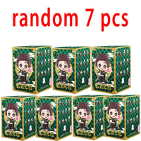 A colorful Demon Slayer Blind Box containing a random cute PVC anime figure of Tanjiro or Nezuko, used as a desktop ornament.