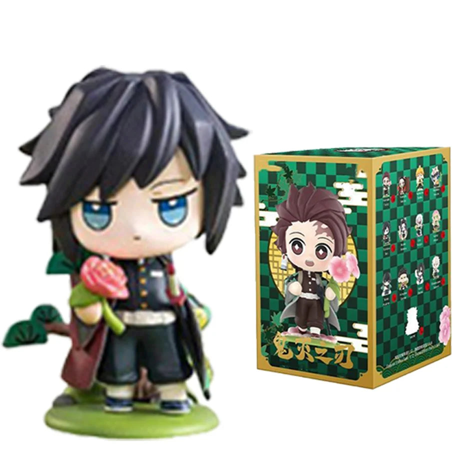 A colorful Demon Slayer Blind Box containing a random cute PVC anime figure of Tanjiro or Nezuko, used as a desktop ornament.