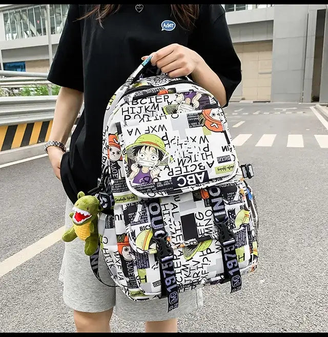 A high-capacity One Piece Luffy Backpack featuring a vibrant graffiti print of Monkey D. Luffy, designed as a durable school bag for middle and high students.