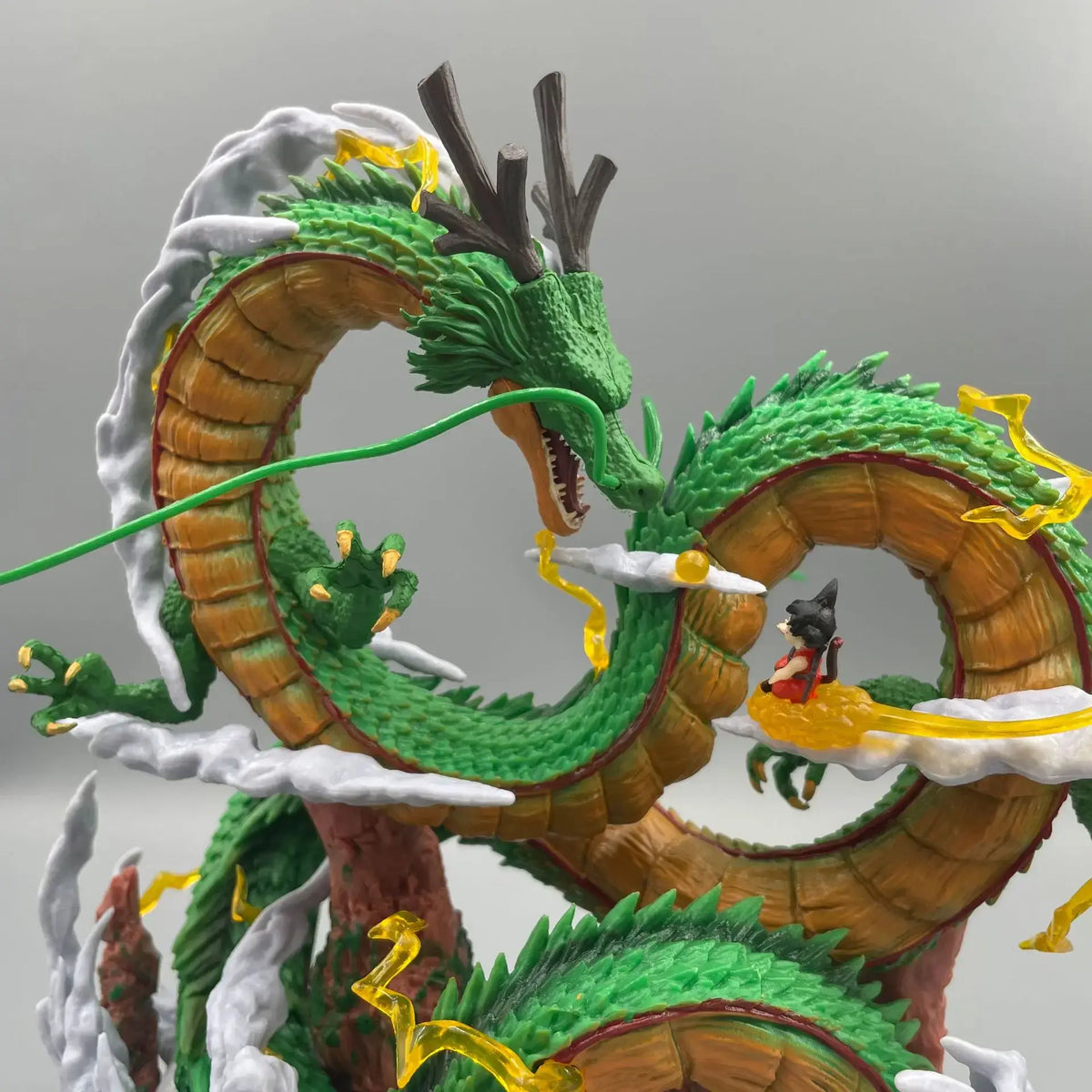A 24cm Dragon Ball Shenron Figure made of high-quality PVC, featuring Son Goku standing with the Eternal Dragon, ideal for anime room decoration.