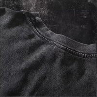 Close-up of the soft fabric texture of the Obito Uchiha Mask Acid Wash T-Shirt in black.