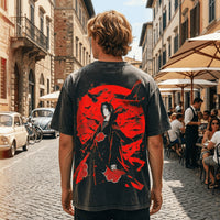 Itachi Uchiha Crow Washed T-Shirt showcasing manga streetwear in a lively outdoor cafe setting.