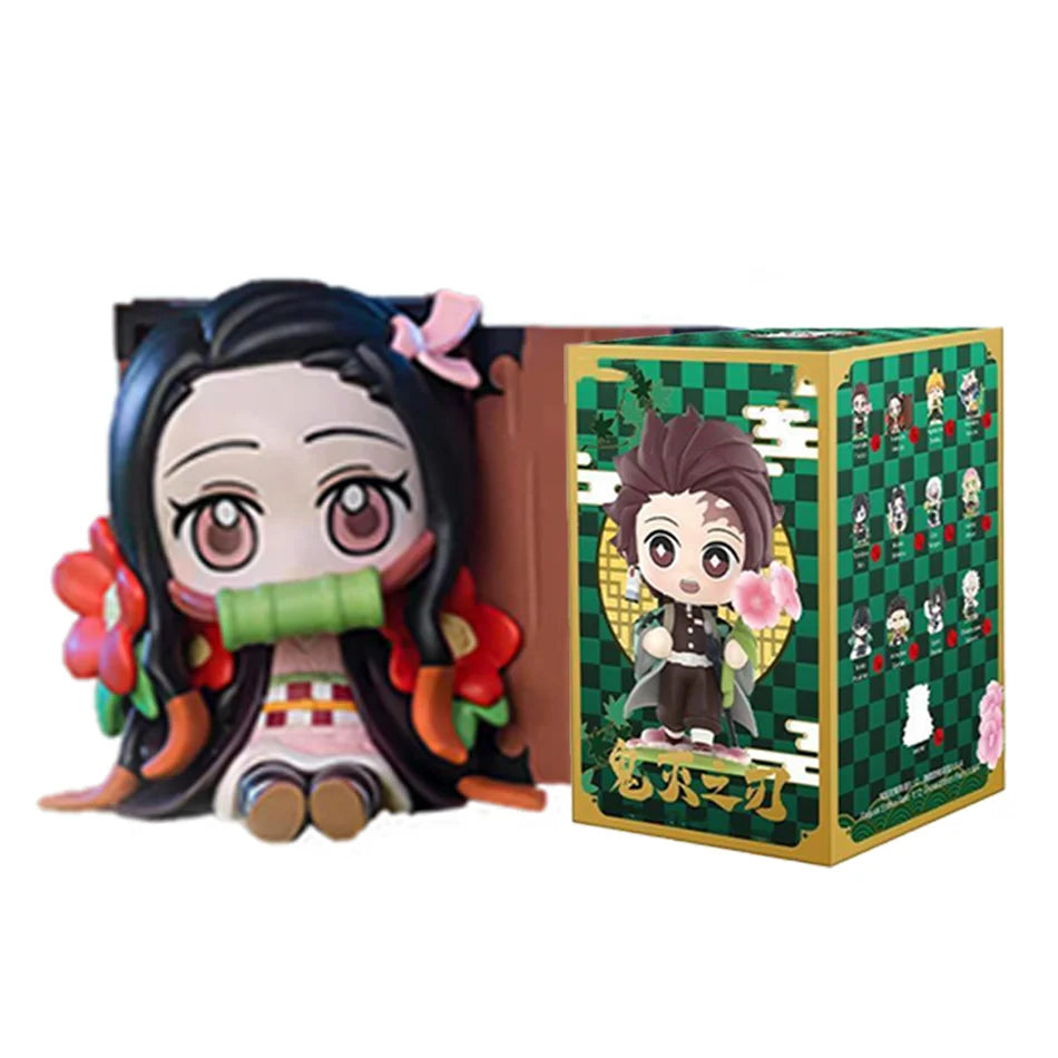 A colorful Demon Slayer Blind Box containing a random cute PVC anime figure of Tanjiro or Nezuko, used as a desktop ornament.