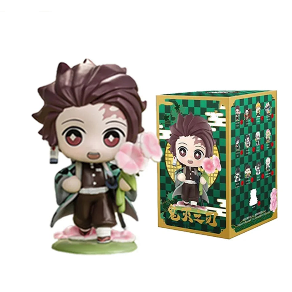 A colorful Demon Slayer Blind Box containing a random cute PVC anime figure of Tanjiro or Nezuko, used as a desktop ornament.