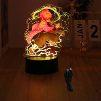 A glowing Demon Slayer 3D Lamp featuring an acrylic Tanjiro and Nezuko figure design, illuminated in blue LED light for bedroom decor.