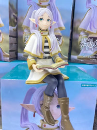 A high-quality 14cm Frieren Anime Figure sitting down, functioning as a noodle stopper and desktop decoration.
