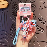 A Genuine Pokemon Keychain featuring a 3D Pikachu and Gengar anime action figure with a fragrance pendant design for backpacks.