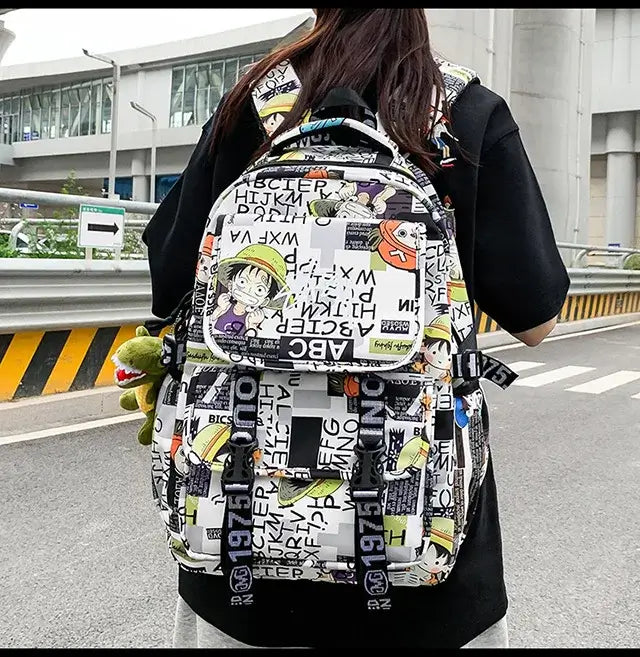 A high-capacity One Piece Luffy Backpack featuring a vibrant graffiti print of Monkey D. Luffy, designed as a durable school bag for middle and high students.