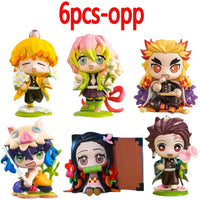 A colorful Demon Slayer Blind Box containing a random cute PVC anime figure of Tanjiro or Nezuko, used as a desktop ornament.