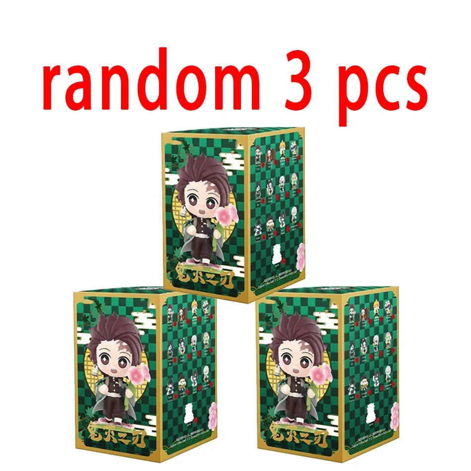 A colorful Demon Slayer Blind Box containing a random cute PVC anime figure of Tanjiro or Nezuko, used as a desktop ornament.