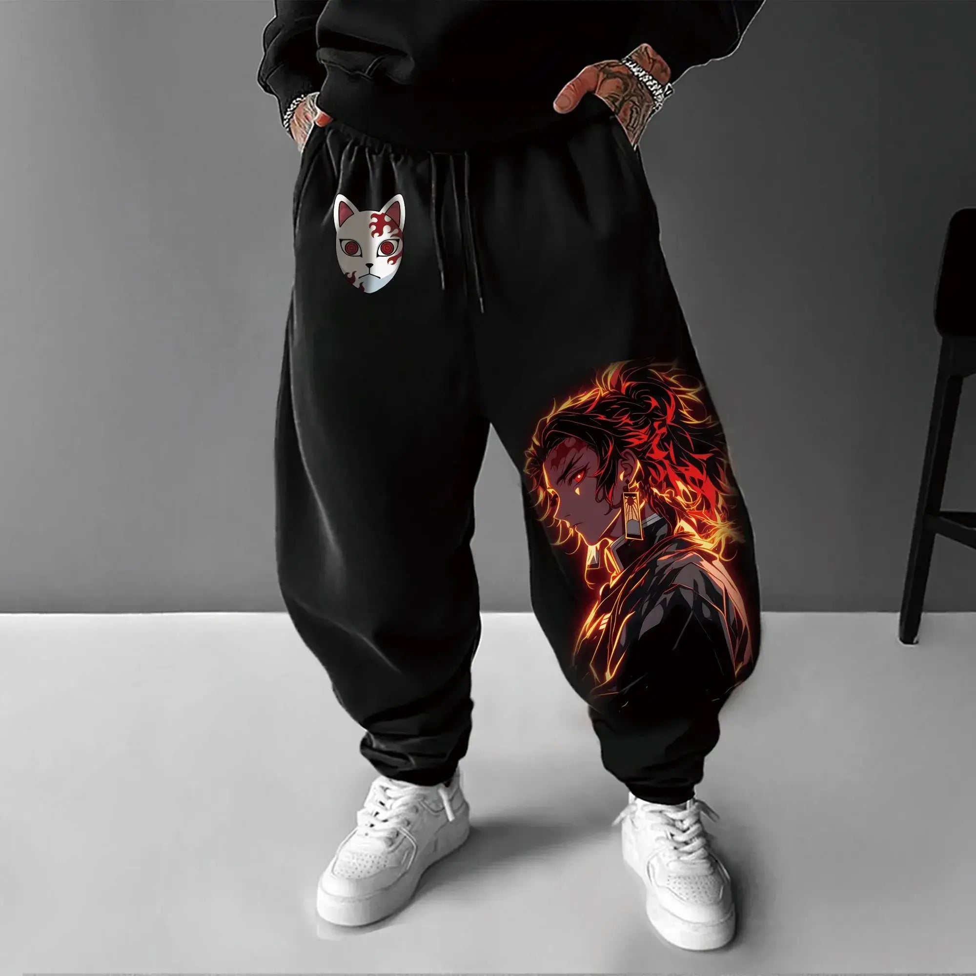 A man wearing the loose-fit Demon Slayer Anime Men Sweatpants with a Japanese cartoon print, showcasing a casual hip hop and Y2K streetwear style.