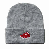 A black knitted Akatsuki Beanie featuring the red cloud embroidery symbol, designed as a warm unisex winter hat for men and women.