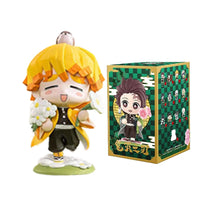 A colorful Demon Slayer Blind Box containing a random cute PVC anime figure of Tanjiro or Nezuko, used as a desktop ornament.