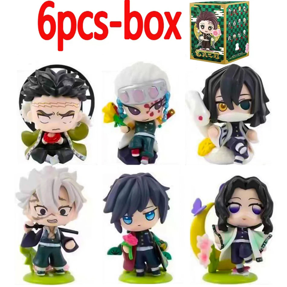 A colorful Demon Slayer Blind Box containing a random cute PVC anime figure of Tanjiro or Nezuko, used as a desktop ornament.
