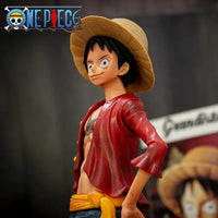 A 28cm One Piece Luffy Figure made of PVC, featuring three interchangeable face plates showing confident and smiley expressions for custom display.
