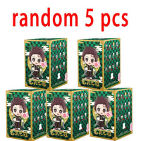 A colorful Demon Slayer Blind Box containing a random cute PVC anime figure of Tanjiro or Nezuko, used as a desktop ornament.