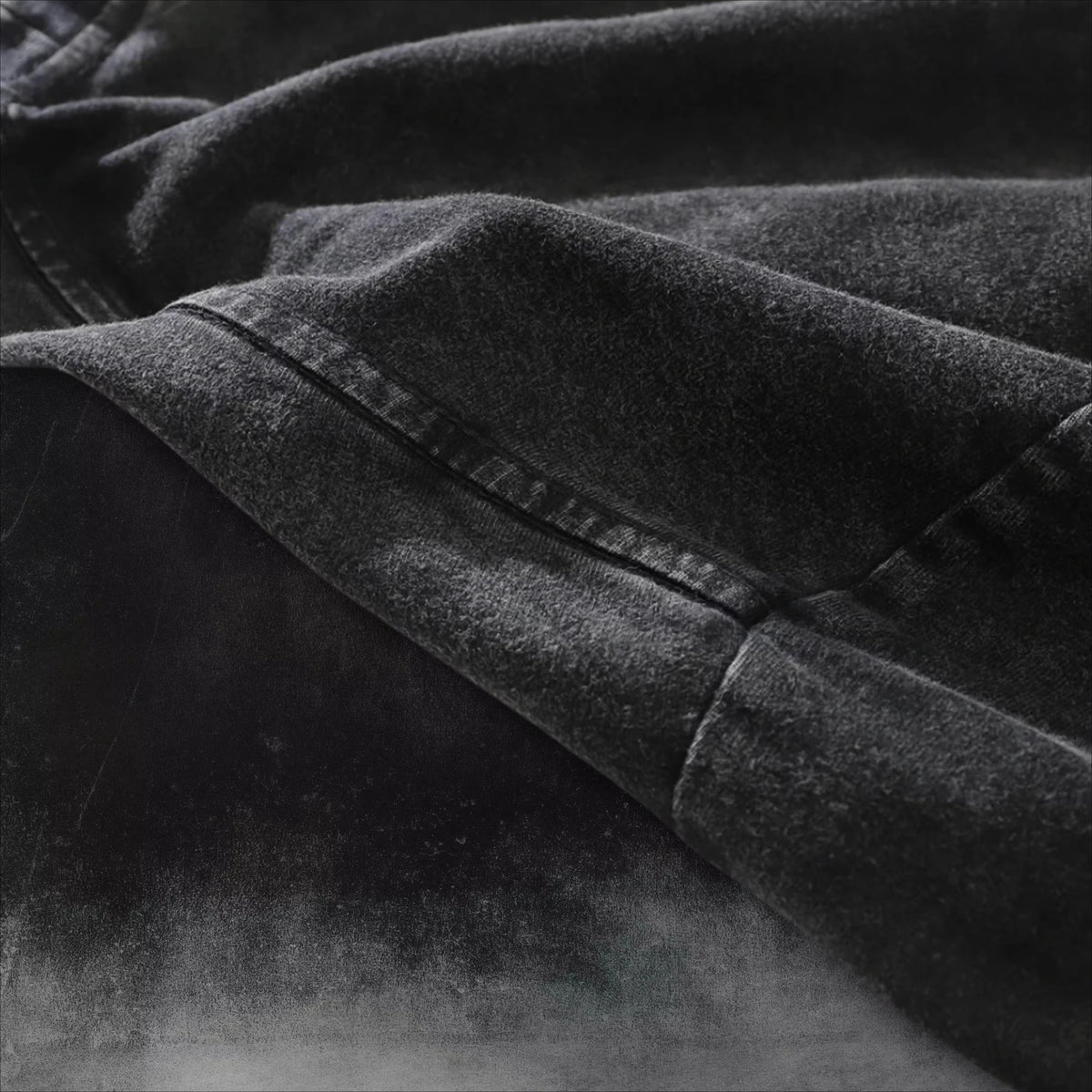 Close-up of the soft fabric texture of the Obito Uchiha Mask Acid Wash T-Shirt in black.