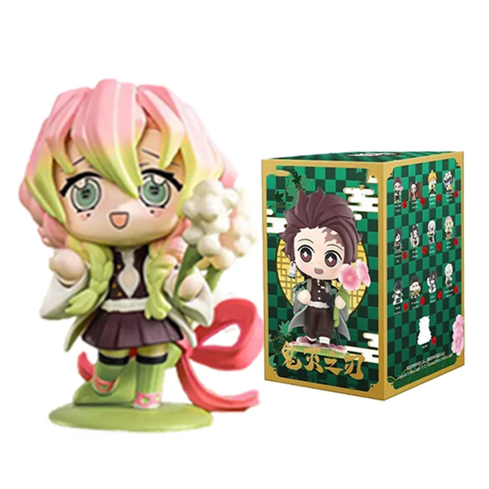 A colorful Demon Slayer Blind Box containing a random cute PVC anime figure of Tanjiro or Nezuko, used as a desktop ornament.