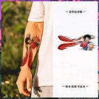 One Piece Temporary Tattoo Stickers illustration showing Luffy with fire fist design on a forearm.