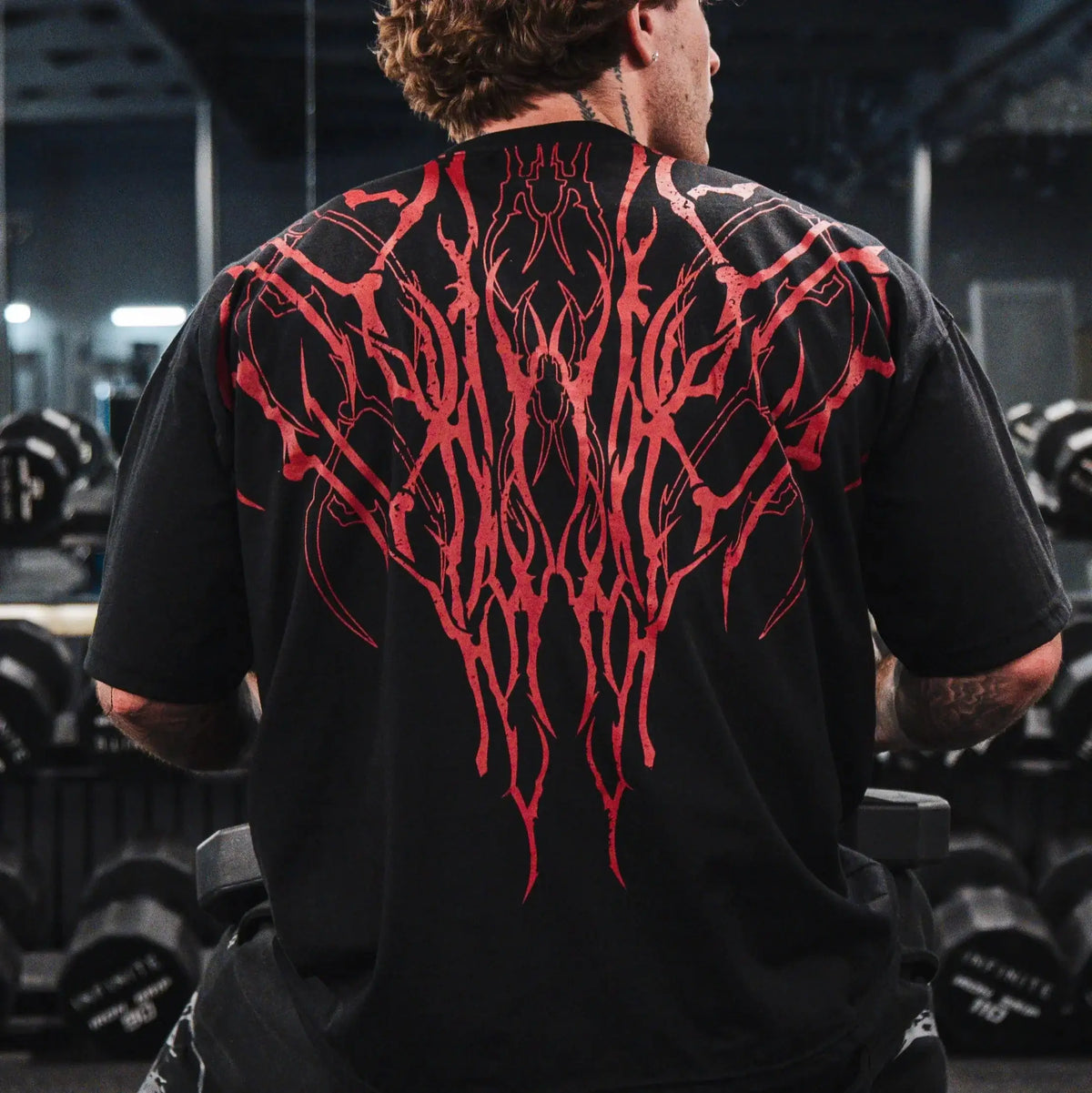 Dark Oversized Cotton Tee Skull Print shown on a model, highlighting the alternative fashion style suitable for men and women's streetwear and gym workouts.