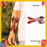 One Piece Temporary Tattoo Stickers illustration showing Luffy with fire fist design on a forearm.