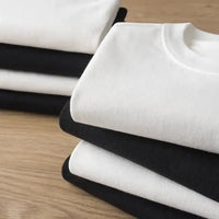 Kokushibo Demon Slayer Breathable Anime T-Shirt in stacked black and white colors on wooden surface.