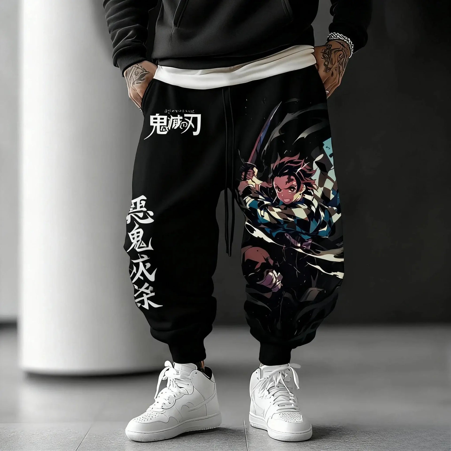 A man wearing the loose-fit Demon Slayer Anime Men Sweatpants with a Japanese cartoon print, showcasing a casual hip hop and Y2K streetwear style.