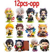 A colorful Demon Slayer Blind Box containing a random cute PVC anime figure of Tanjiro or Nezuko, used as a desktop ornament.