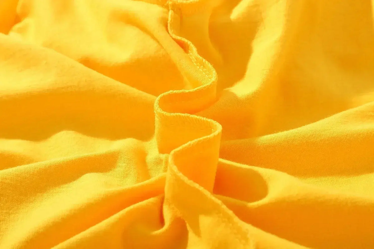 Close-up of soft yellow fabric showcasing the texture of the One Piece Zoro Kids T-Shirt Pure Cotton Boys Top.