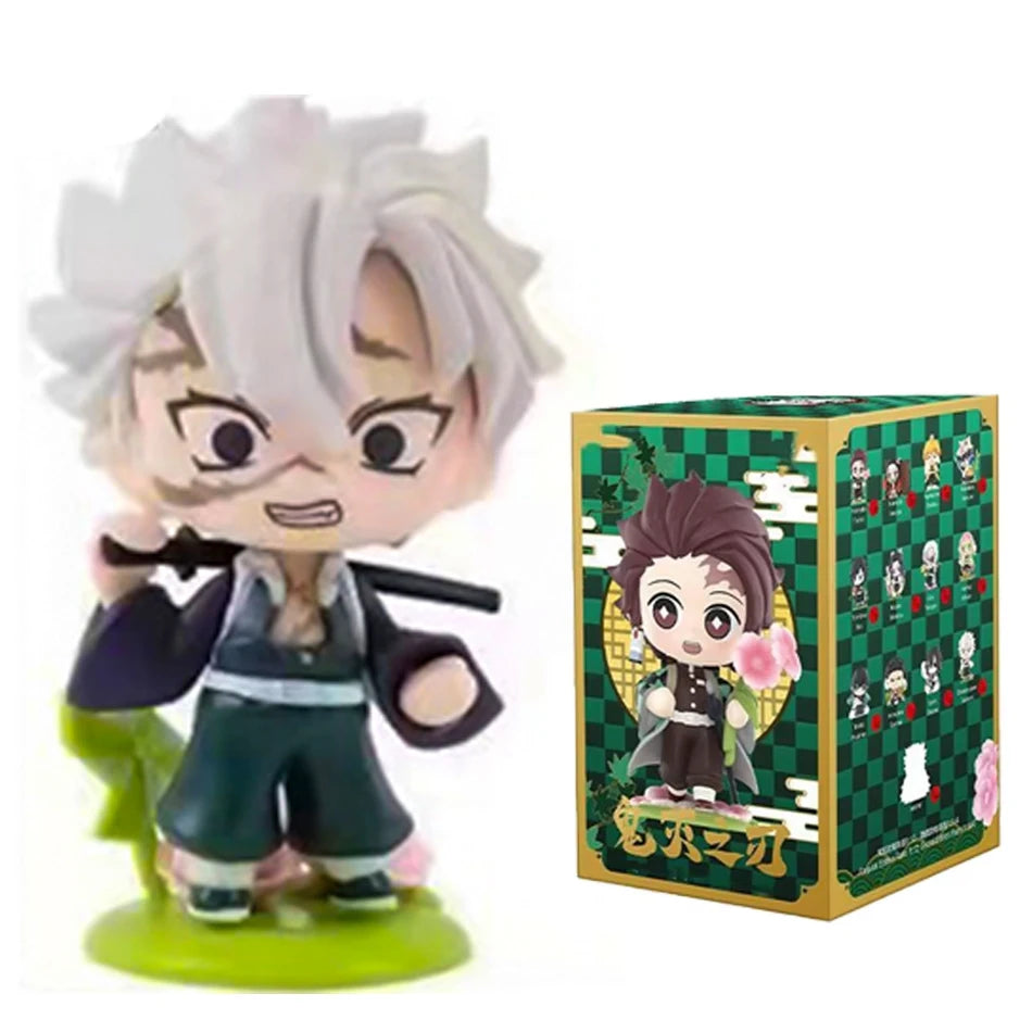 A colorful Demon Slayer Blind Box containing a random cute PVC anime figure of Tanjiro or Nezuko, used as a desktop ornament.