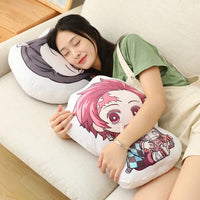 A girl relaxing with Demon Slayer Nezuko Kawaii Stuffed Plush Doll and another anime pillow on a sofa.