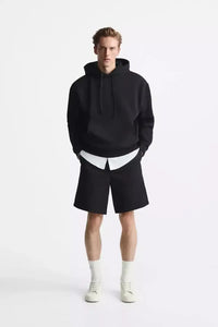One Piece Halloween Hoodie unisex anime costume shown as a casual autumn and winter cosplay outfit Stylish male model wearing a black hoodie and shorts, showcasing modern streetwear fashion.