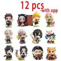 A colorful Demon Slayer Blind Box containing a random cute PVC anime figure of Tanjiro or Nezuko, used as a desktop ornament.