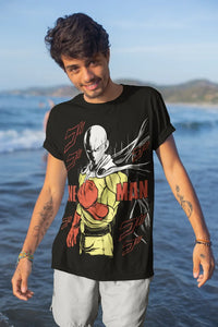Saitama T-Shirt featuring One Punch Man manga art in black cotton, worn by a model on the beach.