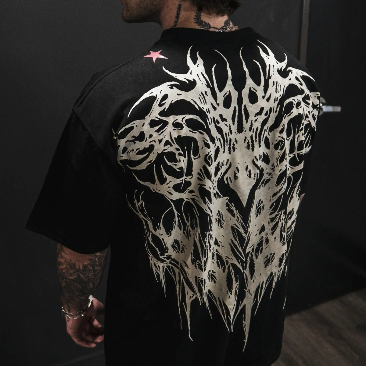 Dark Oversized Cotton Tee Skull Print shown on a model, highlighting the alternative fashion style suitable for men and women's streetwear and gym workouts.