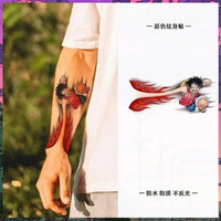One Piece Temporary Tattoo Stickers illustration showing Luffy with fire fist design on a forearm.