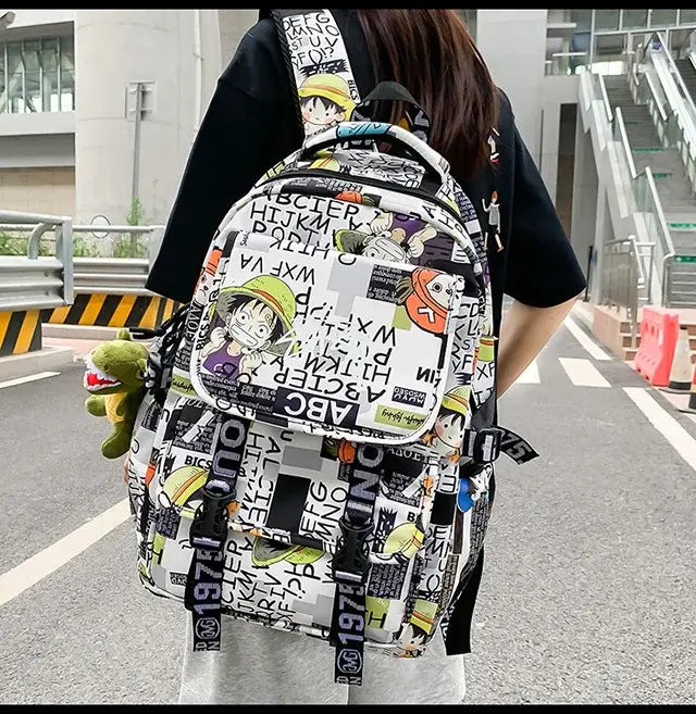 A high-capacity One Piece Luffy Backpack featuring a vibrant graffiti print of Monkey D. Luffy, designed as a durable school bag for middle and high students.