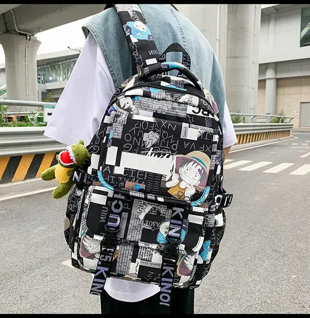 A high-capacity One Piece Luffy Backpack featuring a vibrant graffiti print of Monkey D. Luffy, designed as a durable school bag for middle and high students.