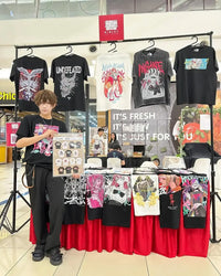 Bleach T-Shirt Vintage Washed Anime Streetwear display at a market featuring various graphic tees and a young model.