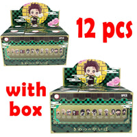 A colorful Demon Slayer Blind Box containing a random cute PVC anime figure of Tanjiro or Nezuko, used as a desktop ornament.