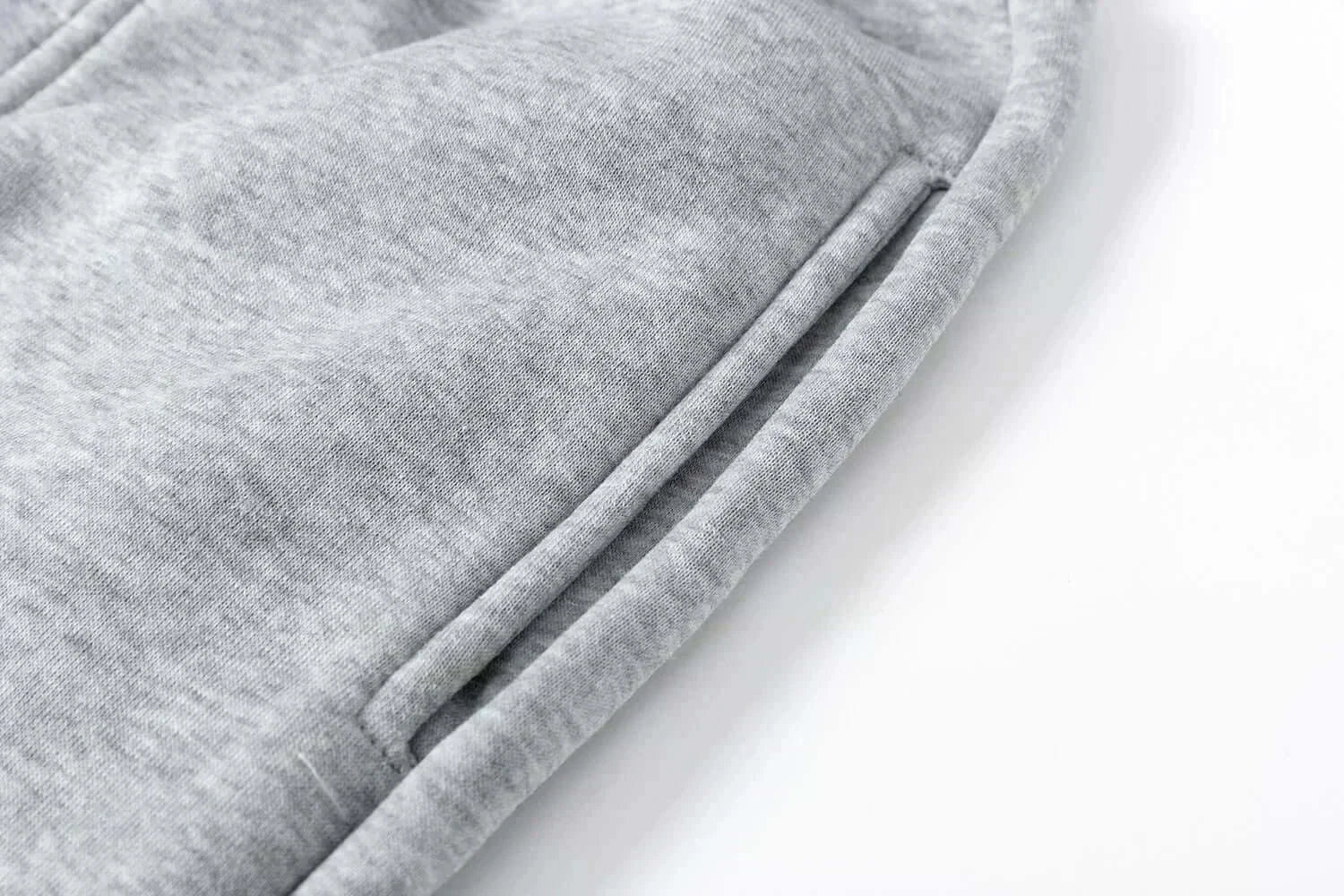 A man wearing the loose-fit Demon Slayer Anime Men Sweatpants with a Japanese cartoon print, showcasing a casual hip hop and Y2K streetwear style.