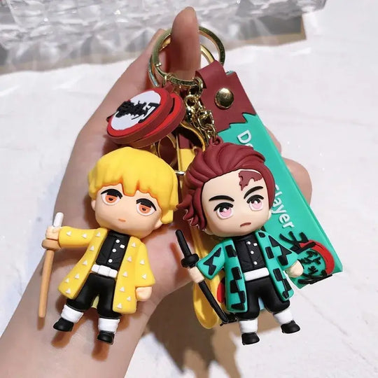 3D Demon Slayer Keychains featuring cute anime character dolls like Tanjiro and Nezuko, used as car ignition accessories and backpack pendants.