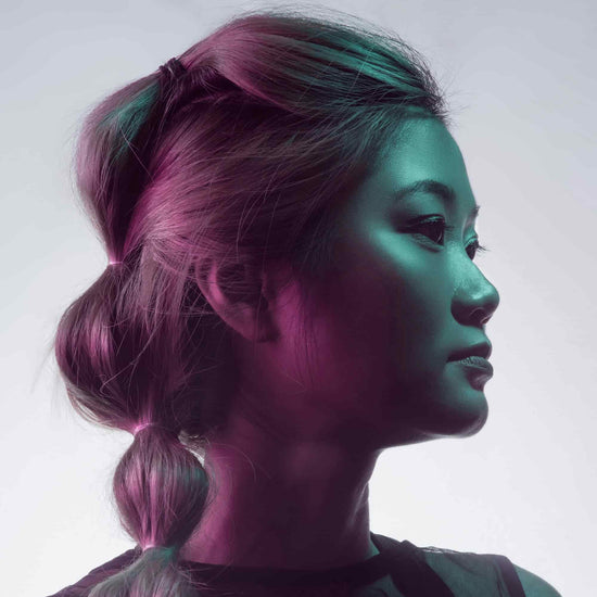 Woman with braided hair in a gradient of pink and green against a white background

